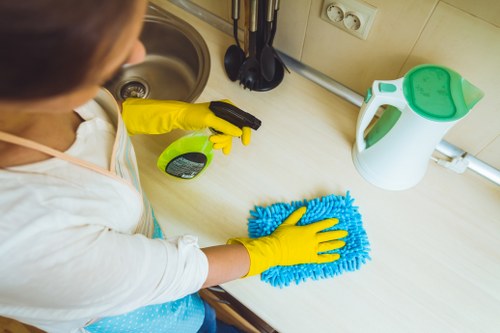Professional cleaners in W6 preparing a modern living room for a deep clean