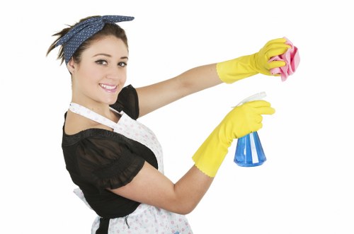 Domestic cleaner vacuuming a hallway in W6